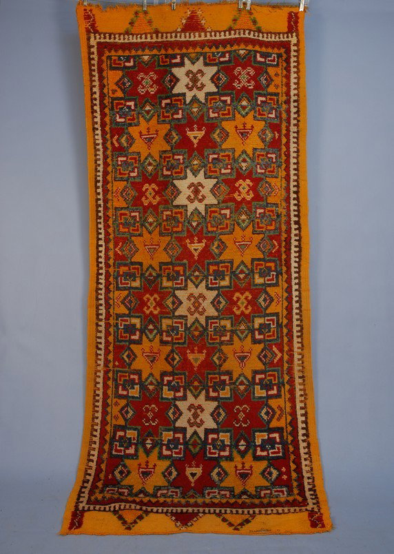 MOROCCAN CARPET, 20th C. Brightly colored in pumpk: MOROCCAN CARPET, 20th C. Brightly colored in pumpkin, red, green, blue and white, with 8-pointed stars and geometric elements. 94 x 40. Good.