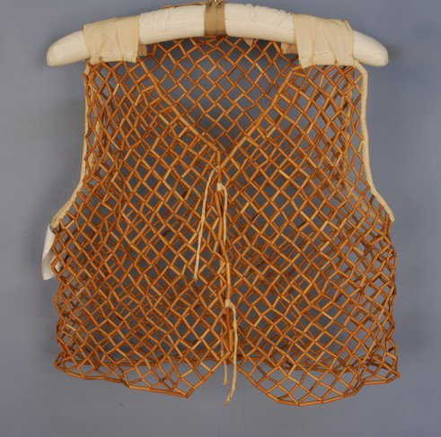A CHINESE OPENWORK BAMBOO VEST, 1st HALF 20th C. N: A CHINESE OPENWORK BAMBOO VEST, 1st HALF 20th C. Narrow tubular sections of bamboo strung together in a lattice/fishnet pattern. Collected and retailed by Adele Simpson. Ch-38, L-19. Excellent.