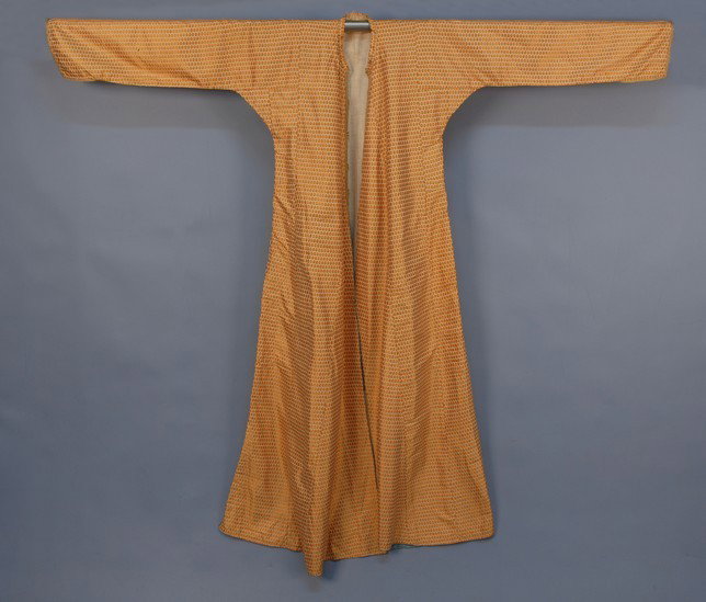 IRAQI SILK COAT, EARLY 20th C. Long robe/coat in o: IRAQI SILK COAT, EARLY 20th C. Long robe/coat in orange, gold and green brocade silk having repeating small flower, with cord trim, two pockets. 66 x 58. Excellent.