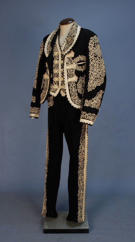 EL INCENDIO, MEXICO, 3-PIECE WOOL and LEATHER SUIT: EL INCENDIO, MEXICO, 3-PIECE WOOL and LEATHER SUIT, 1950's. Black wool felt elaborately decorated with white cut and punched leather trim and soutache, woven leather frog closures. Label "El Incendio"