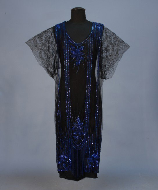 COBALT BEADED and SEQUINNED NET OVER DRESS, 1920's: COBALT BEADED and SEQUINNED NET OVER DRESS, 1920's. Black net with short black lace sleeve decorated with alternating vertical stripes of beads and sequins with elaborate flowers at the neck, above lo