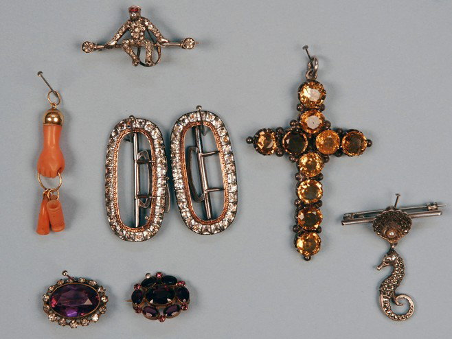 LOT of VICTORIAN JEWELRY. Consisting of a gold and: LOT of VICTORIAN JEWELRY. Consisting of a gold and coral pendant, two small pins with amethyst colored stones, a pair of English shoe buckles with paste jewels, monkey on a bar pin with paste sets, an