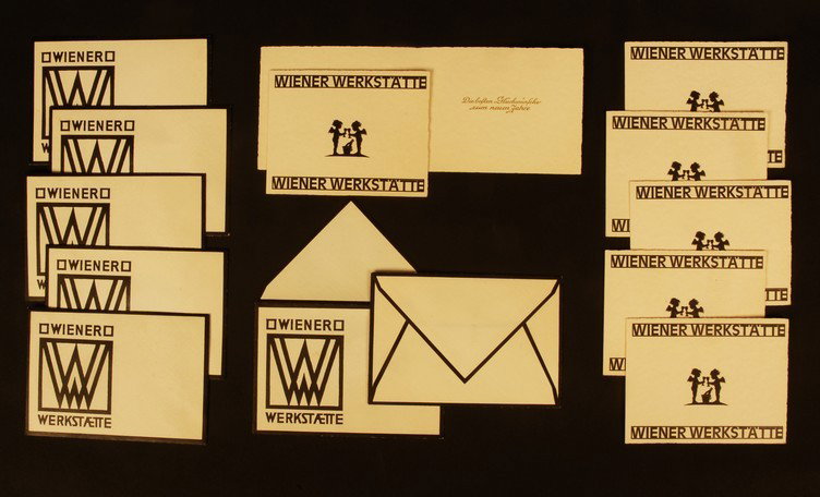 SET of SEVEN WIENER WERKSTATTE NEW YEAR GREETING C: SET of SEVEN WIENER WERKSTATTE NEW YEAR GREETING CARDS. Black on parchment colored stock, the front having small silhouette of two cherubs with champagne glasses and bucket between "WIENER WERKSTATTE"