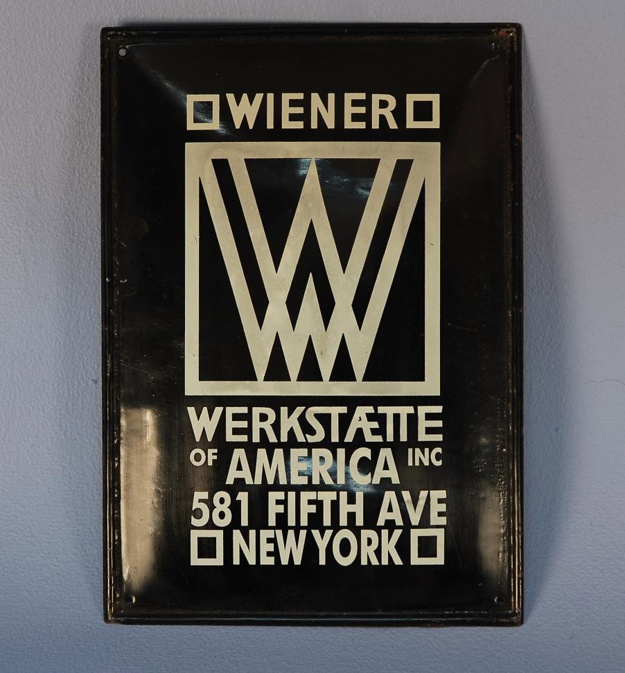 WIENER WERKSTATTE N.Y. BRANCH SHOP ENAMELED SIGN, : WIENER WERKSTATTE N.Y. BRANCH SHOP ENAMELED SIGN, c. 1922 Period black enameled metal rectangle with white lettering depicting the signet of the WW New York shop at 581 Fifth Avenue which opened in 19