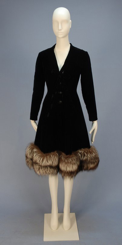 PAULINE TRIGERE COCKTAIL DRESS with FOX HEM, MID 2: PAULINE TRIGERE COCKTAIL DRESS with FOX HEM, MID 20th C. Black velvet with long, narrow zippered sleeve, V-neck with self tie above three square domed jet buttons, A-line skirt trimmed with a wide hem