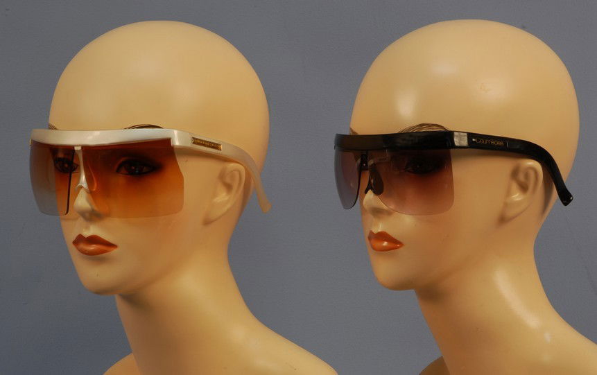 TWO PAIR COURREGES PARIS SUNGLASSES, 1960's. Ident: TWO PAIR COURREGES PARIS SUNGLASSES, 1960's. Identical style, one black, one white. Plastic frame with molded nosepiece, left side raised label, inside frame marked "Courreges Paris" and "7853 B Franc