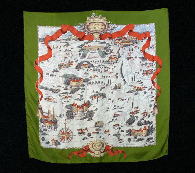 HERMES PRINTED SILK TWILL "CHEMINS" MAP SCARF. Cre: HERMES PRINTED SILK TWILL "CHEMINS" MAP SCARF. Cream with green border, pale blue, green, brown and light brick red printed map "Les Chemins de L'Ile-de-France" with illustrations of Paris, Chartres, 