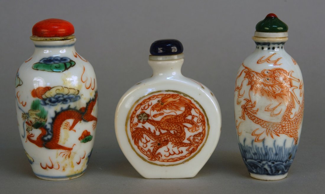 THREE CHINESE PORCELAIN SNUFF BOTTLES, 19th C. All : THREE CHINESE PORCELAIN SNUFF BOTTLES, 19th C. All white body with polychrome decoration: Two with phoenix and dragon, one with dragon only. Excellent.