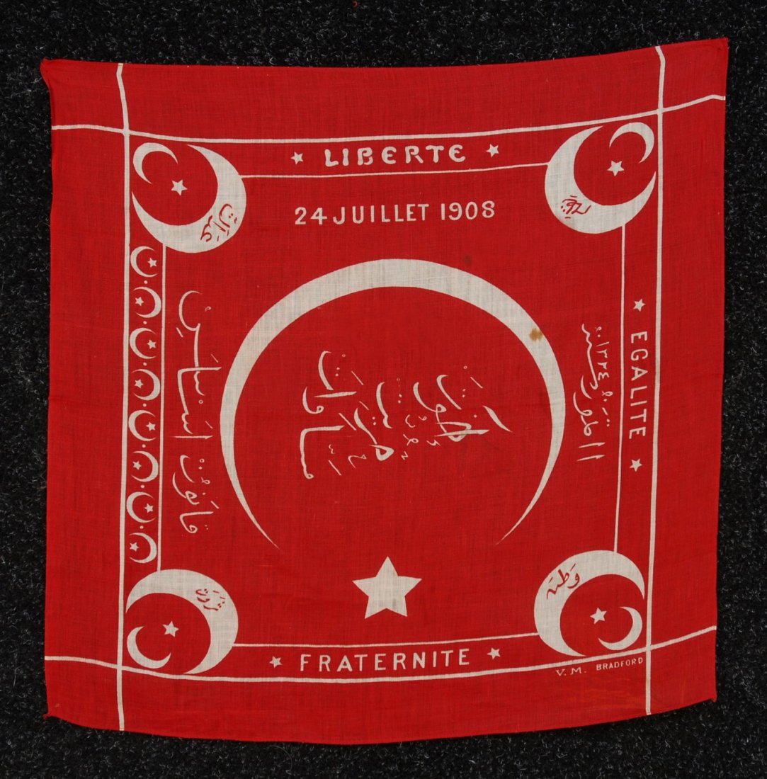TURKISH COMMEMORATIVE BANDANA, 20th C. Celebrating : TURKISH COMMEMORATIVE BANDANA, 20th C. Celebrating the reinstatement of the national constitution by the Sultan, July 24, 1908. Red and white muslin with crescent moons and stars, motto, date and Turk