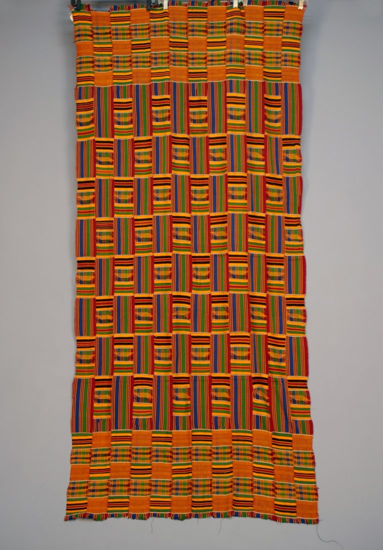 WOMAN'S AFRICAN ASANTE KENTE CLOTH, GHANA, 20th C.: WOMAN'S AFRICAN ASANTE KENTE CLOTH, GHANA, 20th C. Strip woven rayon in a pattern of vivid striped and plaid blocks. 37 x 84. Excellent.