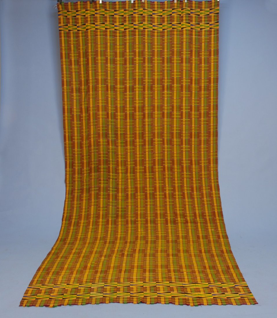 MAN'S AFRICAN ASANTE KENTE CLOTH, GHANA, 20th C. S: MAN'S AFRICAN ASANTE KENTE CLOTH, GHANA, 20th C. Strip woven rayon in a pattern of vivid stripes over stripes, two end bands with a repeat of long triangles. 60 x 140. Excellent.