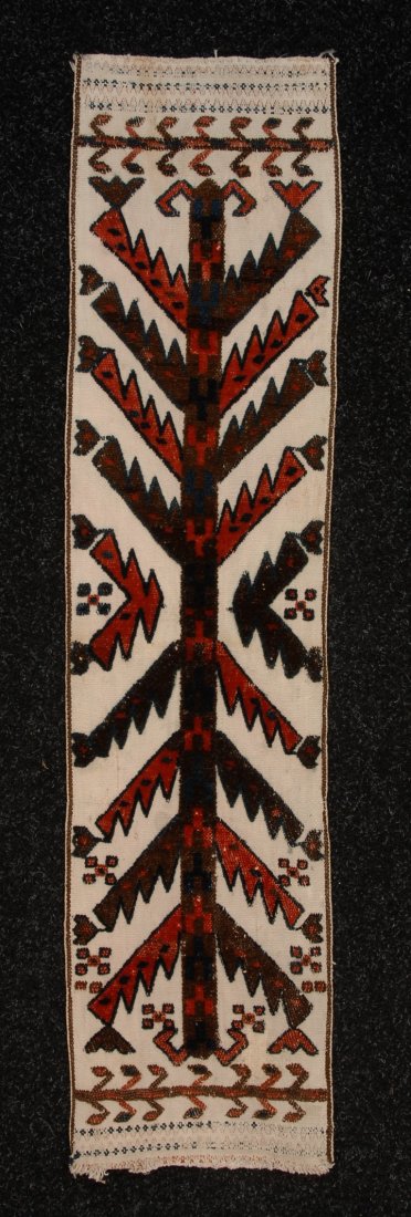 YOMUD TENT HANGING, 20th C. Woven white cotton wit: YOMUD TENT HANGING, 20th C. Woven white cotton with piled sawtooth geometric design in brown, red and blue, 9 x 38. (Wear at ends) otherwise excellent.