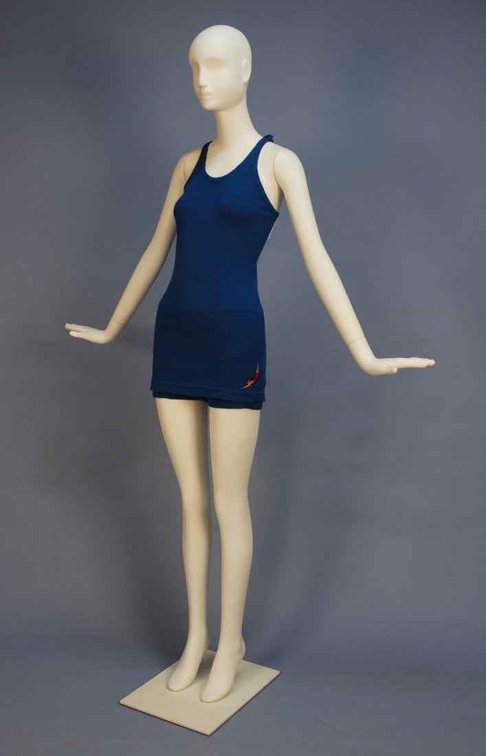 LADY'S JANTZEN MAILLOT with DIVER APPLIQUE, 1930's: LADY'S JANTZEN MAILLOT with DIVER APPLIQUE, 1930's. French blue wool maillot with Jantzen applique at left hem, Strawbridge & Clothier Jantzen label and attached paper label, size 44. (Two minor moth 
