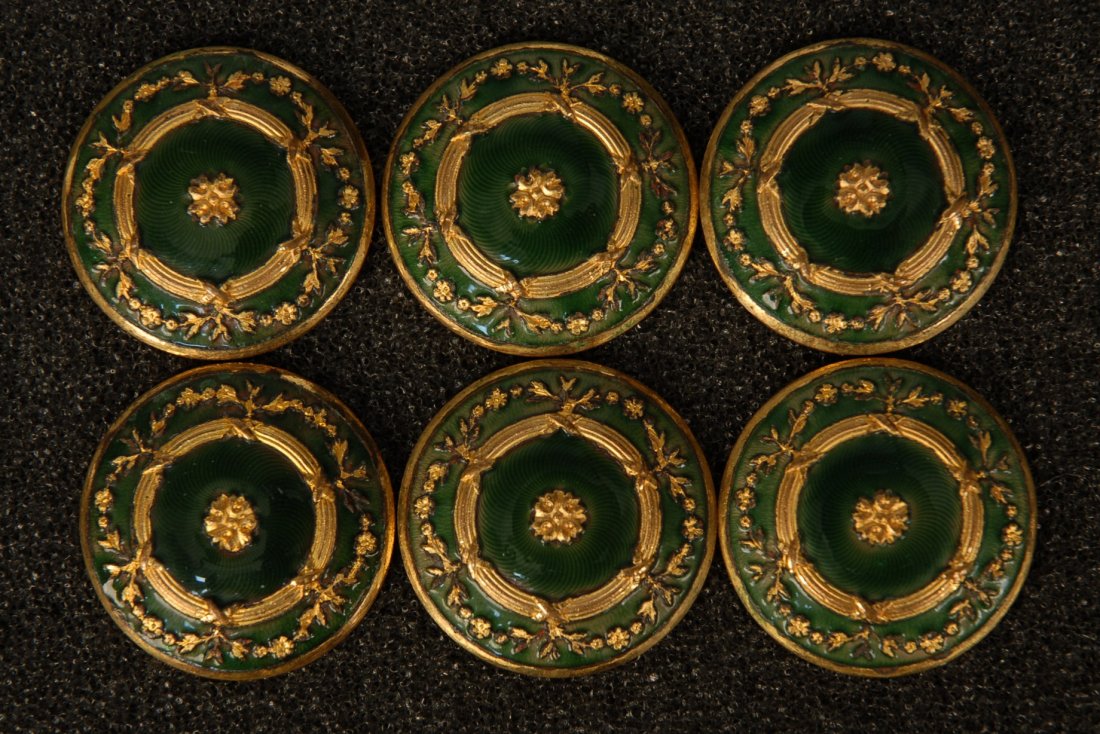 SET of SIX CHAMPLEVE ENAMEL BUTTONS. Large 1-piece: SET of SIX CHAMPLEVE ENAMEL BUTTONS. Large 1-piece gilt metal with loop shank having floral swag and ribbon design on green enameled ground. 1 1/4. Excellent.