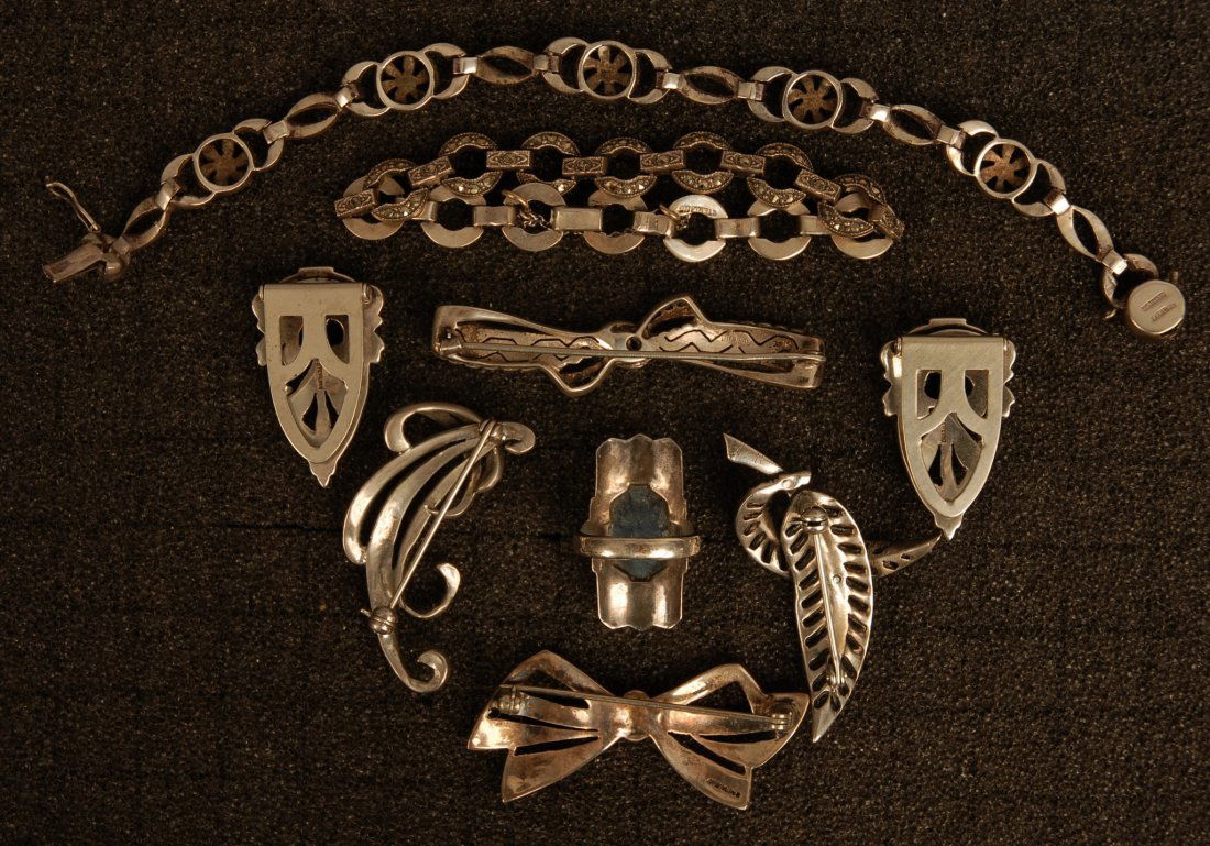 LOT of MARCASITE JEWELRY EARLY-MID 20th C. Consist: LOT of MARCASITE JEWELRY EARLY-MID 20th C. Consisting of four pins, pair of clips, two link bracelets and a large ring set with sodalite. Good-excellent.