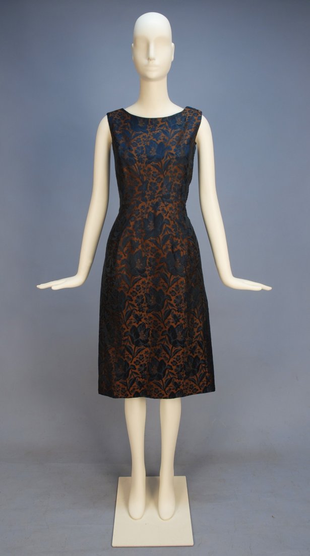 GIVENCHY COUTURE SILK BROCADE COCKTAIL DRESS 1960': GIVENCHY COUTURE SILK BROCADE COCKTAIL DRESS 1960's. Navy floral on brown silk, sleeveless with princess styling and narrow skirt, side zipper and shoulder closure, satin lining. Label "Givenchy Paris