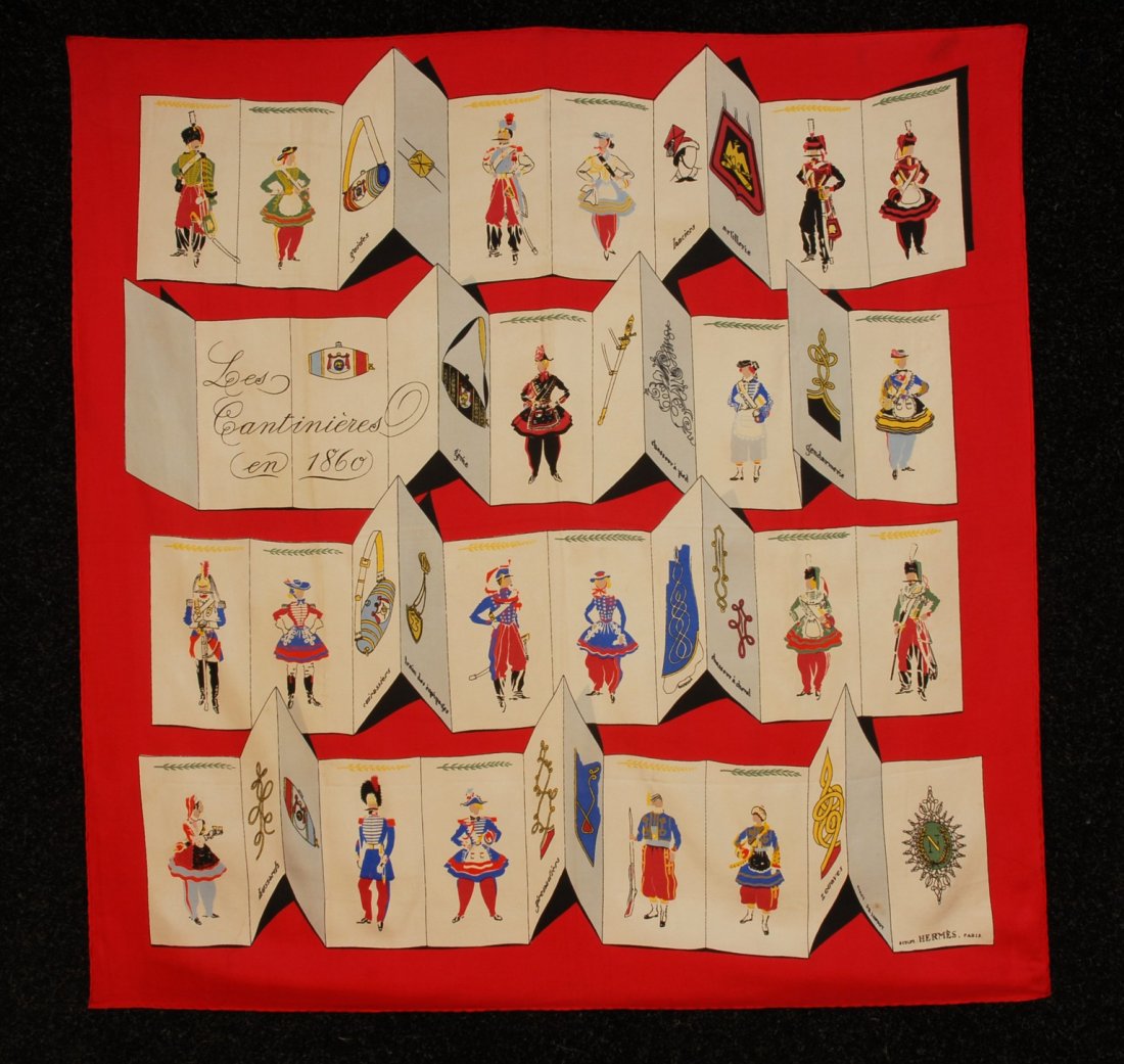 HERMES PRINTED SILK TWILL "LES CANTINIERES EN 1860: HERMES PRINTED SILK TWILL "LES CANTINIERES EN 1860" SCARF, 1953 DESIGN. Musical themed having folded cards with figures in period uniforms and costumes on red ground. "SCULPT. :HERMES, PARIS" within d