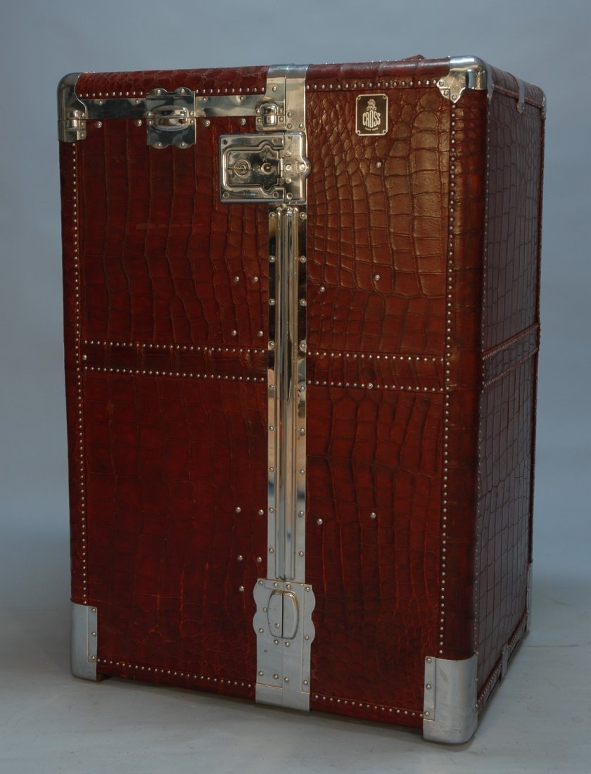 MARK CROSS WINE RED ALLIGATOR STEAMER TRUNK, MID 2: MARK CROSS WINE RED ALLIGATOR STEAMER TRUNK, MID 20th C. Standing and ball castered large trunk with high polish chromed hardware opening to reveal left hanging compartment with original hangers and d