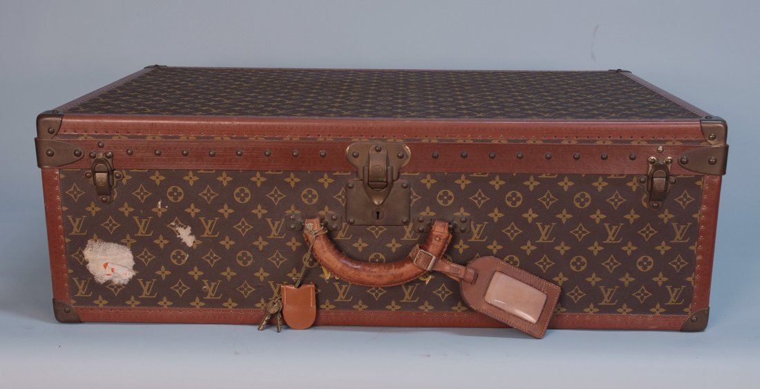 A VINTAGE LOUIS VUITTON HARD SUITCASE. Full leathe: A VINTAGE LOUIS VUITTON HARD SUITCASE. Full leather trim and brass corners with "LV" stenciled logo surface, removeable interior tray, momogrammed "W.B. McC". 31 x 21 x 10. (No key, handle probably re