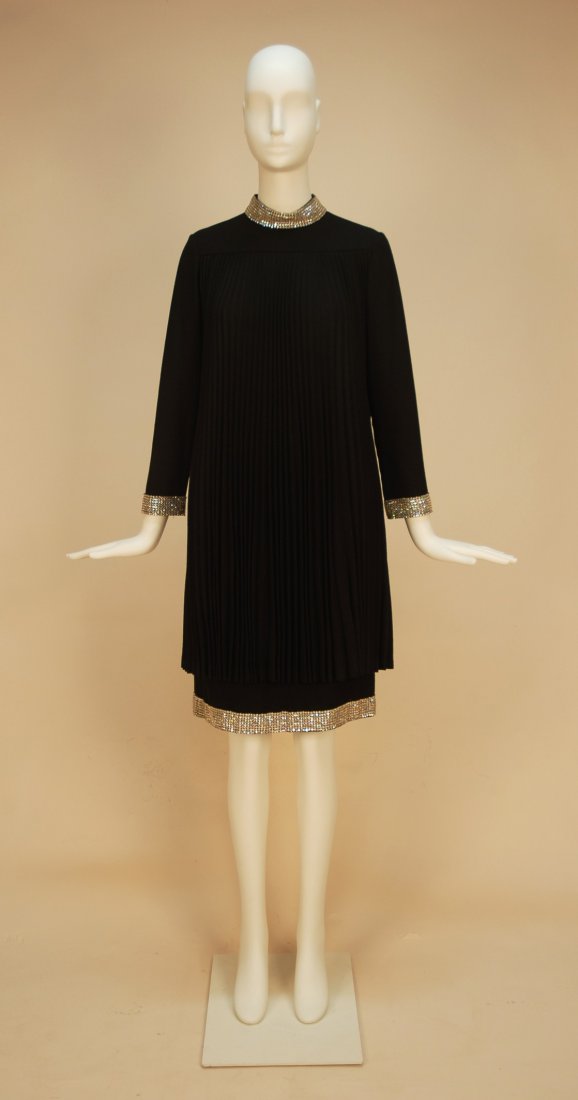 TEAL TRAINA WOOL TRAPEZE DRESS with RHINESTONES, c: TEAL TRAINA WOOL TRAPEZE DRESS with RHINESTONES, c. 1965. Black long sleeve with wide rhinestone banded neck, sleeve and hem, having knife pleated tunic layer falling from yoke almost to hem, back zip