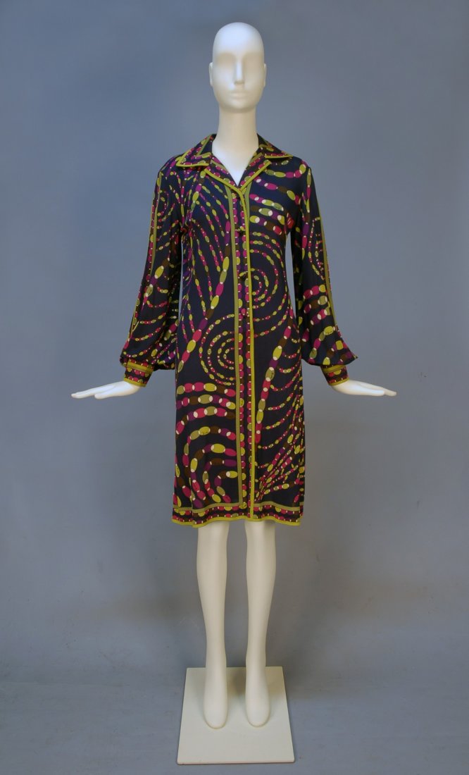 PUCCI PRINTED SILK JERSEY SHIRT DRESS, c. 1970. Na: PUCCI PRINTED SILK JERSEY SHIRT DRESS, c. 1970. Navy ground and signature "Emilio" print having stylized strands of beads in plum, magenta, olive, brown and white, with long full sleeve gathered into 