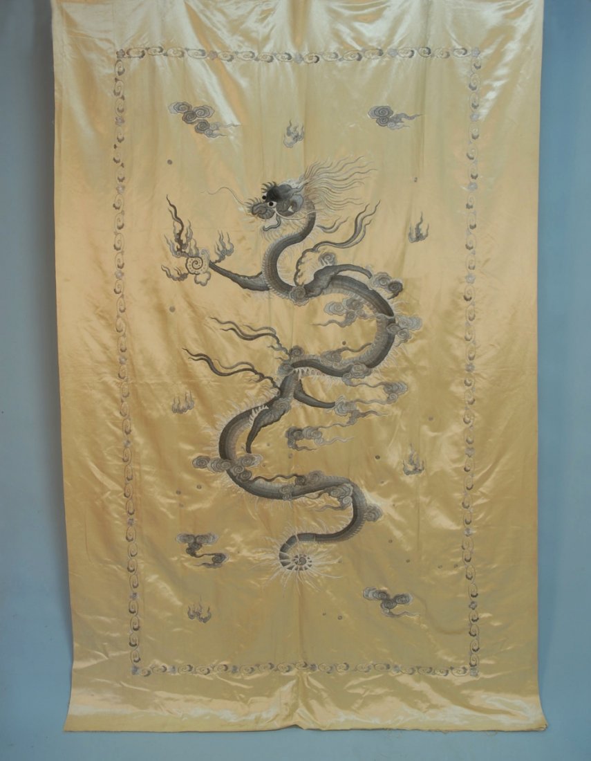 CHINESE or JAPANESE EMBROIDERED PANEL, EARLY 20th C: Pale yellow silk satin elaborately decorated with a 2-tone gray dragon worked in padded embroidery. 84 x 54. Excellent.