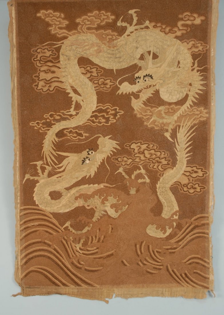 JAPANESE EMBROIDERED TAPESTRY, EARLY 20th C.: Two dragons among clouds and waves elaborately worked on padded satin stitch and couched threads, in brown and ivory tones. 43 x 62. (Some loose threads) very good.