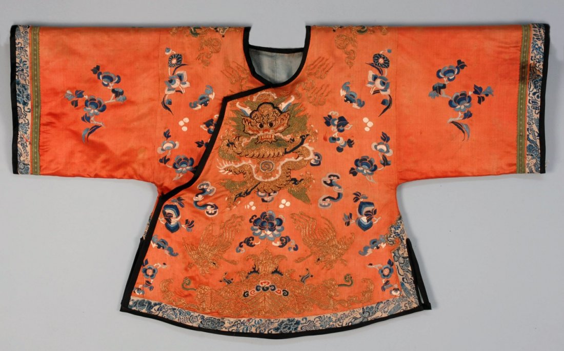 CHINESE DRAGON ROBE, EARLY 20th C.: Child's size in peach silk satin with two gold dragons in couched thread. 39 x 23. (Soiling) good.
