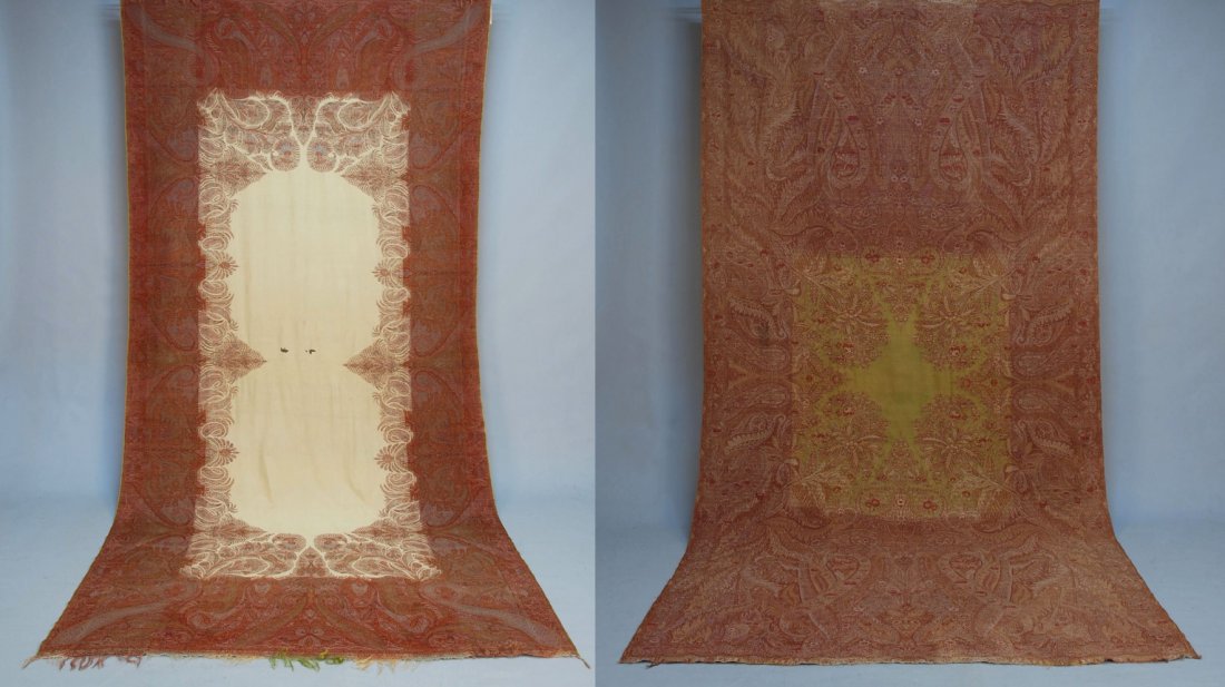 TWO PAISLEY SHAWLS, 19th C.: Both long shawls, probably French: One with green square center having unusual leafy design within paisley. 118 x 58. Excellent. One with square ivory floral center. 118 x 61. (Two substantial holes i