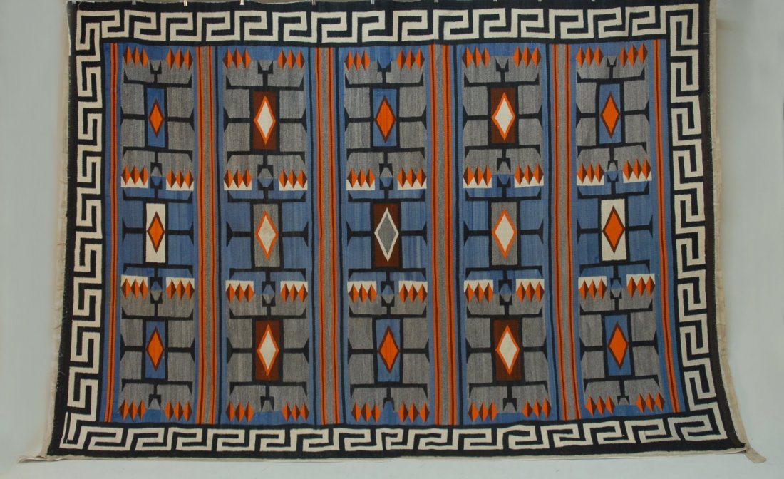 NAVAJO RUG, EARLY 20th C.: Teec Nos Pos in large cabin size, fifteen rectangular devices containing stylized water bugs in grey, brown, blue and orange surrounded by Greek key border. 149 x 88. IMA. (Minor repairs) excellent.