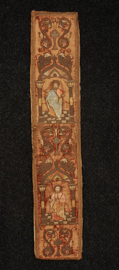 CONTINENTAL EMBROIDERY, 18th C.: Narrow panel with saints, dragons, and architectural elements worked in silk and metallic threads on red velvet. 52 x 10. (Velvet completely worn) embroidery excellent.