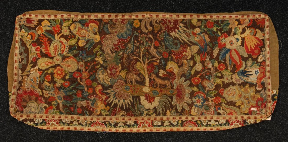 NEEDLEPOINT BENCH COVER, 19th C.: Large rectangle decorated with birds in central tree flanked by lion and elephant on an overall floral ground. 22 x 57. (Splits and losses) fair.