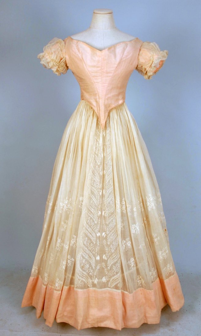 WHITEWORK EMBROIDERED COTTON and SILK DRESS, 1840': 2-piece white mull, open neck boned bodice over pink silk satin, having short stiffened puffed sleeve, deep front point, back laces and padded bust. Full skirt with cartridge pleats decorated with flo