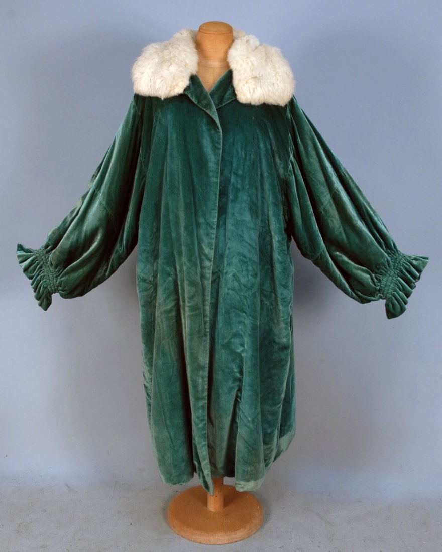 PANNE VELVET EVENING COAT, EARLY 20th C.: Seafoam silk with wide sleeve having triple ruched cuff with ruffle, wide white fur collar, satin lining with inside pocket and tie. Bonwit Teller label. L-46. (Tiny spot, minor fur loss) good.