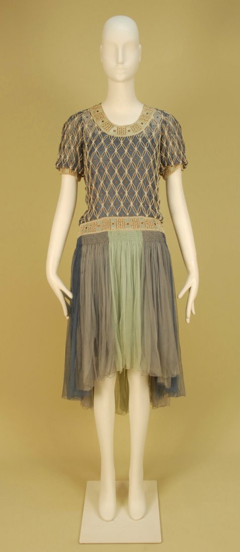 SUZANNE TALBOT PARIS BEADED CHIFFON EVENING DRESS,: Blue bodice decorated with a lattice of pearls and copper metallic thread having a lighter blue band at neckline and hem of short puffed sleeve, matching decoration at the dropped waist, ruched skirt 