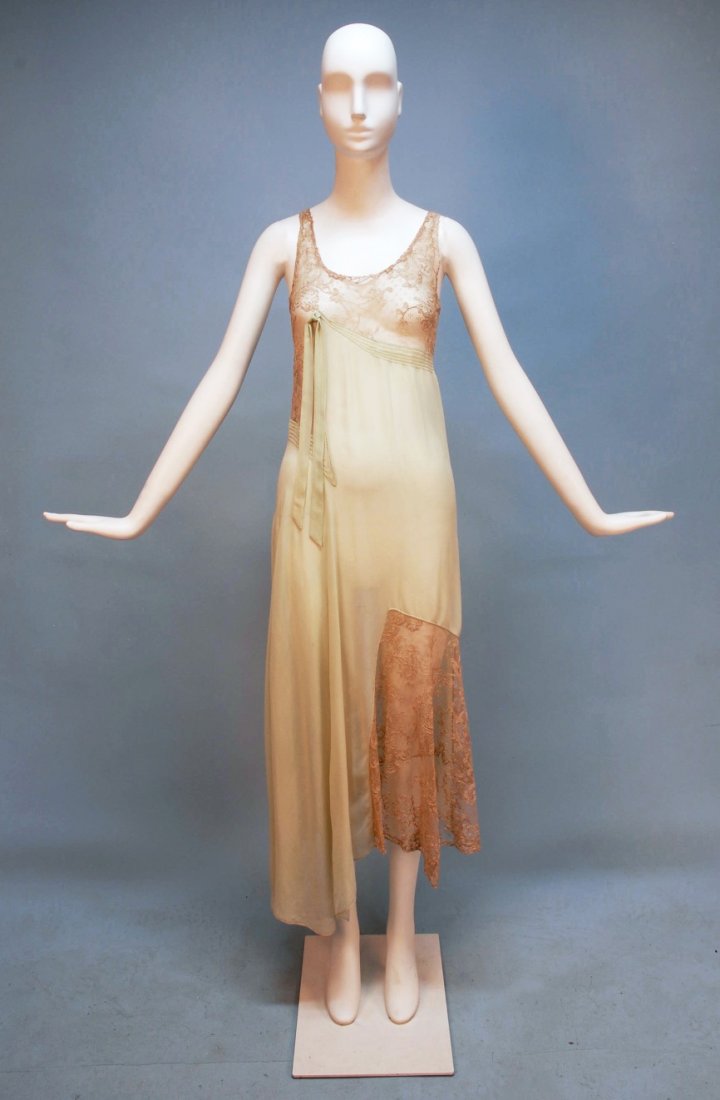 FRENCH ASYMETRICAL CHIFFON and LACE NIGHTGOWN, c. : Mint green silk with ecru Alencon lace having narrow chiffon bands and bow bordering the lace bodice, skirt with lace panel at left hem and longer hemline with point at right. Label "Made in France" B