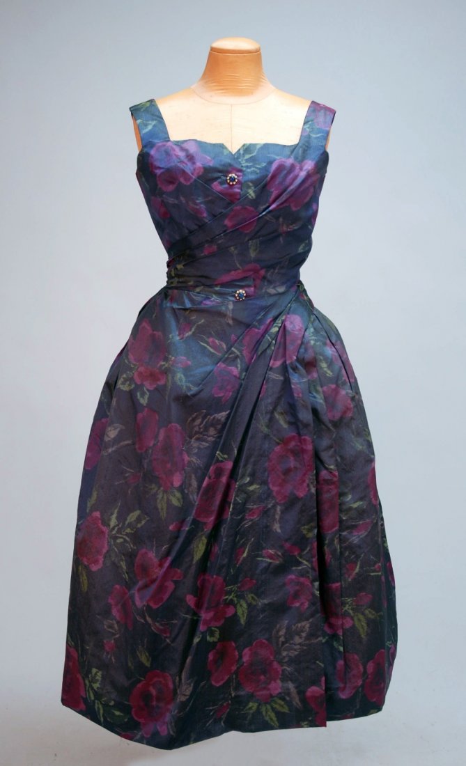 PIERRE BALMAIN COUTURE WARP PRINTED SILK PARTY DRE: Sleeveless with wide strap and fitted surplice bodice with notched square neckline and two faux buttons with blue cabochons set in a ring of paste jewels, in blue with plum and green floral print, set
