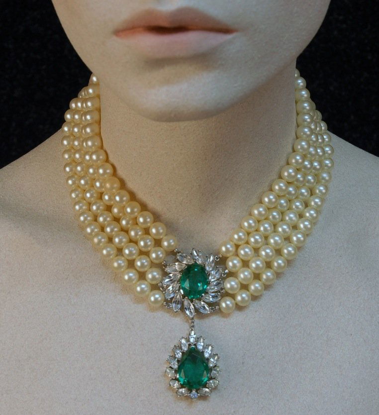 TRIFARI NECKLACE and EARRING SET with FAUX EMERALD: Four strand choker of faux pearls having central oval faceted green jewel and teardrop shaped pendant, both with marquise cut rhinestones, matching oval ear clips. Marked "Trifari" on clasp and clip.