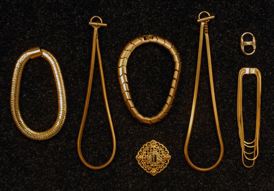 FIVE DESIGNER GILT METAL NECKLACES, 20th C.: One YSL "snake" collar, L-17 1/4, (missing YSL tag). One Givenchy brushed finish "S" shaped link, L-18. Two YSL ropes with ring and bar closure, L-25 1/2. One YSL having five ropes of graduated length