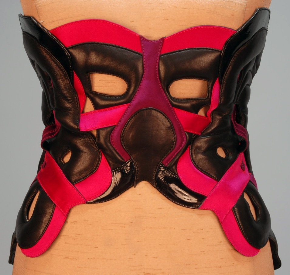 ALEXANDER McQUEEN DEADSTOCK LEATHER and SATIN COR: Pierced and padded black leather trimmed in fuchsia and purple satin and black patent leather, metal grommets and back laces. Marked size small, leather impressed "Alexander McQueen Made in Italy", pr