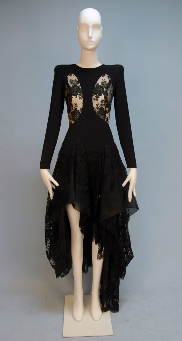 ALEXANDER McQUEEN DEADSTOCK CREPE and LACE DRESS : Long sleeve black wool and silk blend, bodice having black lace insertion over cream chiffon, asymmetrical skirt with lace gores and widely irregular hemline, padded shoulder, back zipper. Labeled and