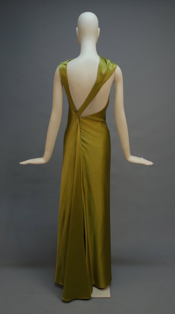 CHADO RALPH RUCCI HAMMERED SATIN ASYMMETRICAL EVE: Sleeveless acid green bias cut silk with draped boatneck and open back having tapering straps meeting at left side above skirt drape, off-center hidden back zipper, black silk lining. Labeled. B-32, W