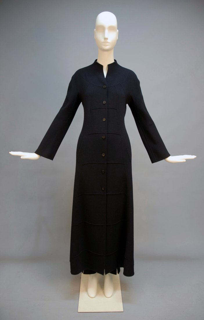 CHADO RALPH RUCCI "DALAI LAMA" COAT and PANT ENSE: Navy double faced wool crepe coat having rounded yoke and raised princess seams curving to side slit at hem with hidden pockets, flanking front and back panel with ribbed stitching creating a ladder e
