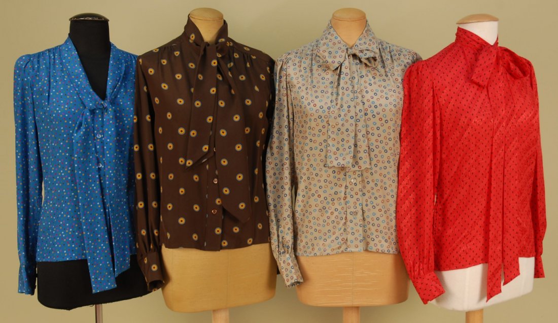 FOUR SAINT LAURENT RIVE GAUCHE PRINTED SILK BLOUS: Various dotted patterns, three having tie/bow at neck. All labeled. Blue and red size 34, taupe size 38, brown size 40. Excellent.
