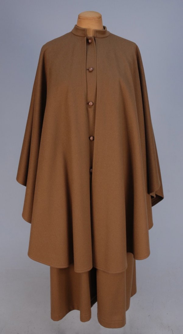 SAINT LAURENT RIVE GAUCHE WOOL CAPE COAT, 20th C.: Light brown sleeveless A-line coat having stand collar, side seam pockets, domed composition buttons, circle cape falling from collar, unlined. Labeled. B-40, L-46. Excellent.