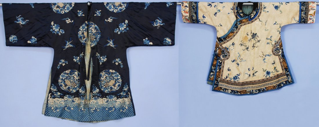 TWO CHINESE SHORT ROBES, 19th - 20th C.: One white silk brocade with butterflies and flowers, (tears at neck) good. One in blue satin with roundels of satin stitch, butterflies and forbidden stitch flowers, (lining shattered, collar over-cas