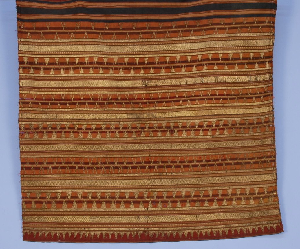 INDONESIAN LANPUNG TAPIS CEREMONIAL CLOTH, 19th or EARL: Very fine tapestry weave silk stripe in earth tones heavily embroidered and couched with gold metallic threads. Reduced to 44 x 46. (Abrasions, small holes, stain, loose gold threads) good.