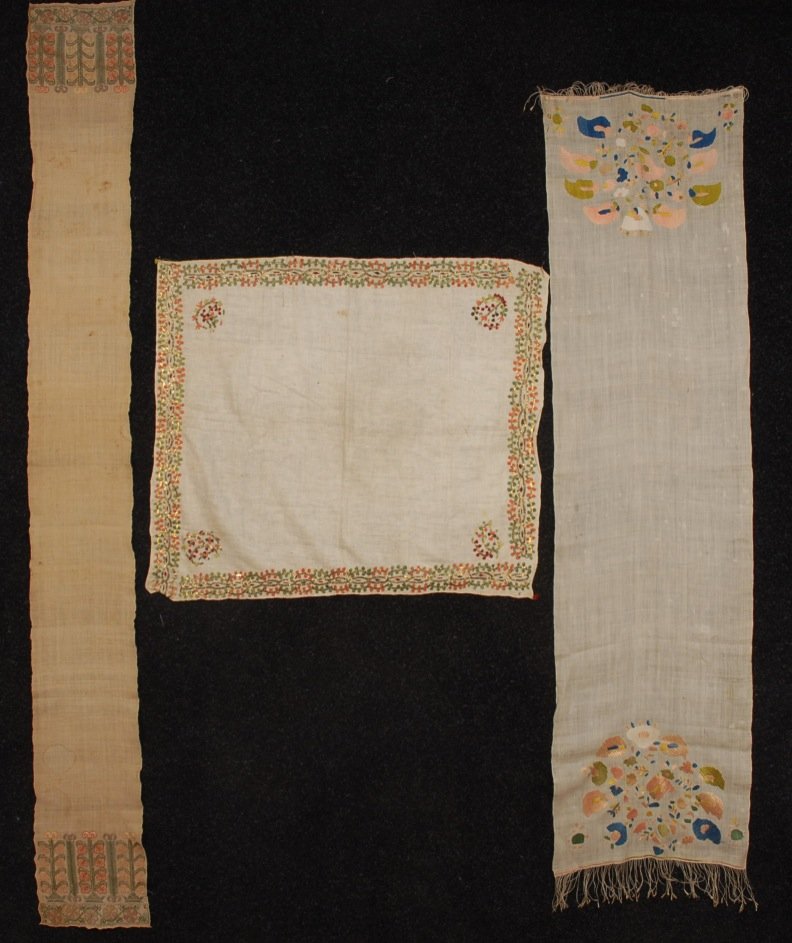 THREE MIDDLE EASTERN SILK EMBROIDERIES on LINEN, EARLY: Two Bursa towels, one having pulled threadwork and metallic gold threads, 9 x 78 and 17 x 66. One square with silk and metallic border having stylized floral corners, 28 x 28 (light stains, mends) goo