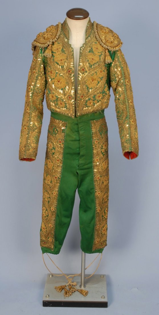 SPANISH MATADOR "TRAJE de LUCES" COSTUME, 20th C.: Consisting of jacket (chaquetilla), vest and trousers (telequilla) in emerald green satin encrusted with metallic gold braid and sequin applique and embroidery with gold cord tassels (machos) and clar