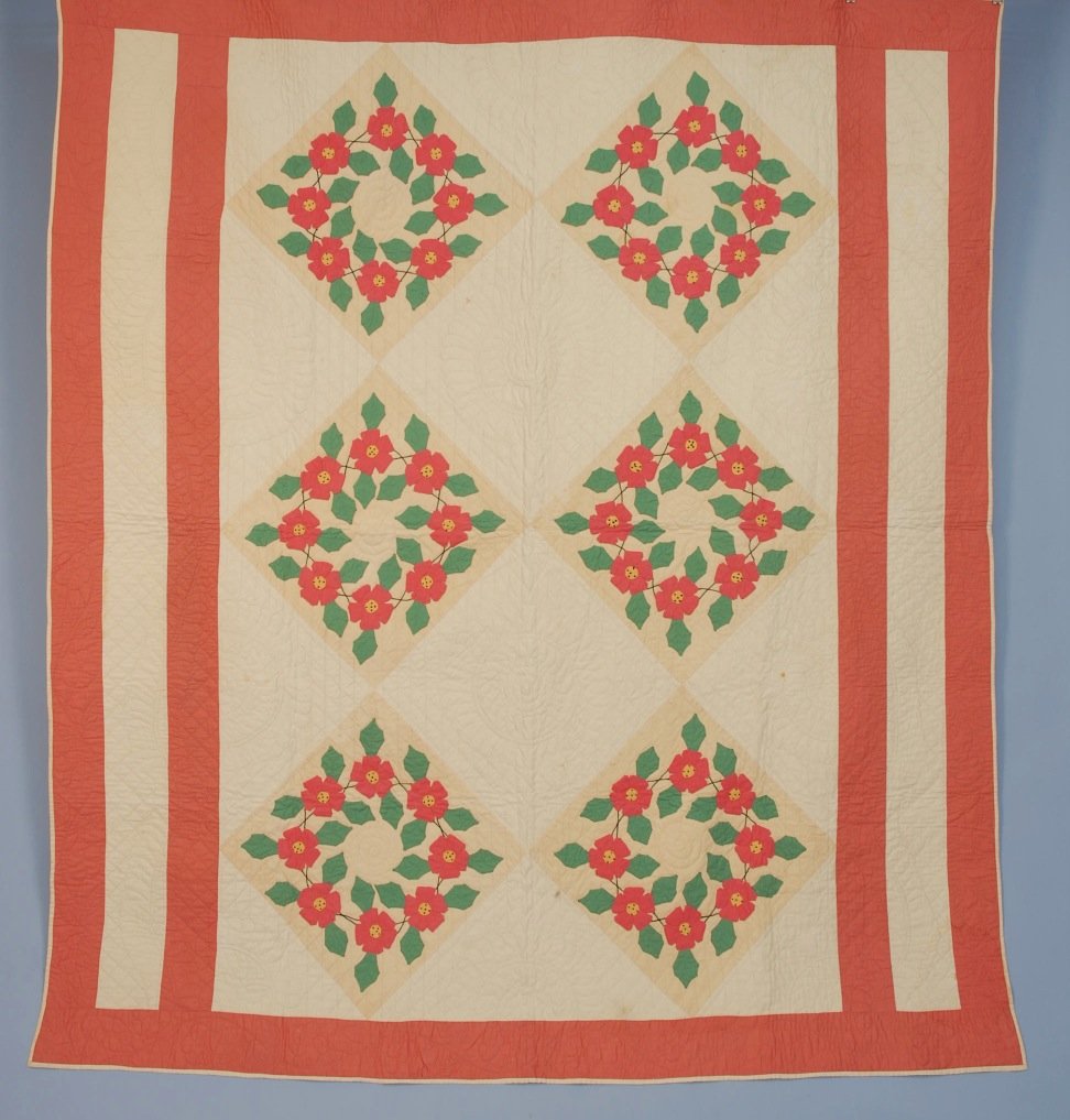 PIECED and APPLIQUED QUILT, 1930's.: Six large pink and green floral wreaths on buff square within double bar pink borders, white field quilted with circular medallions, floral and leaf scrolling vines, white cotton verso. 78 x 70. (Two 